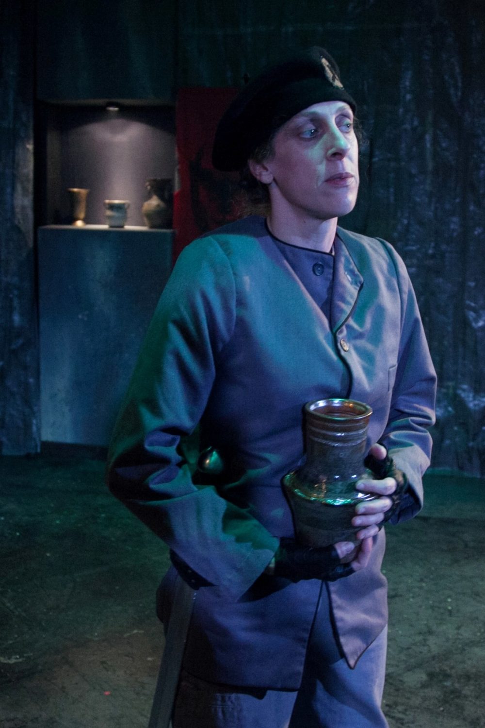 General Titus stands holder the urn of her deceased child