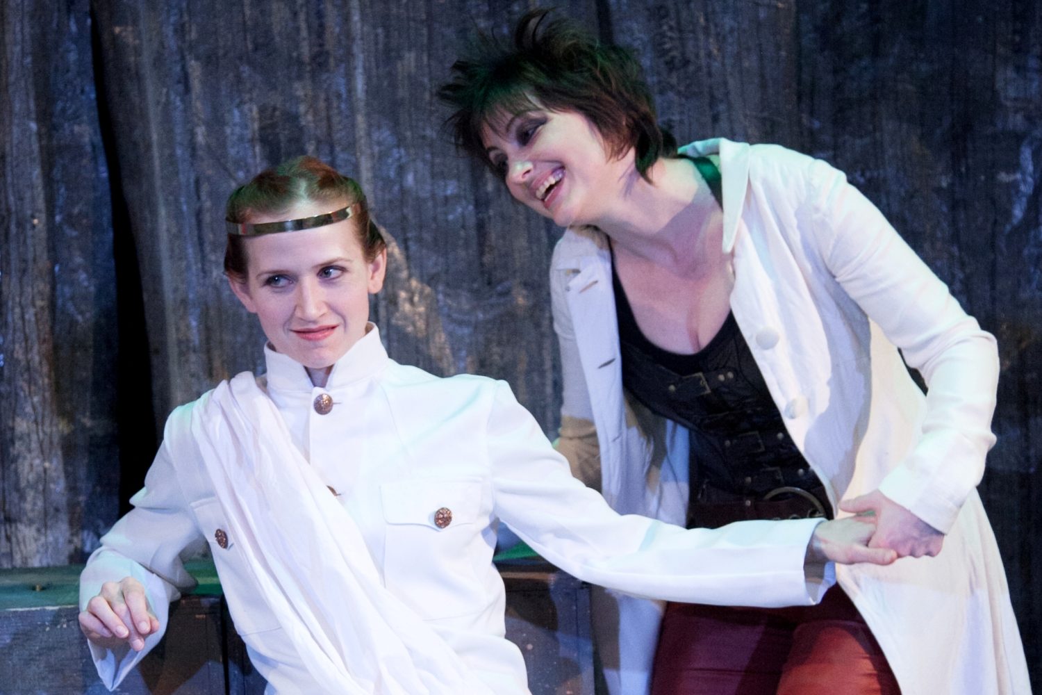 Emperor Saturninas sits on her throne with Goth Queen, Tamora, doting over her