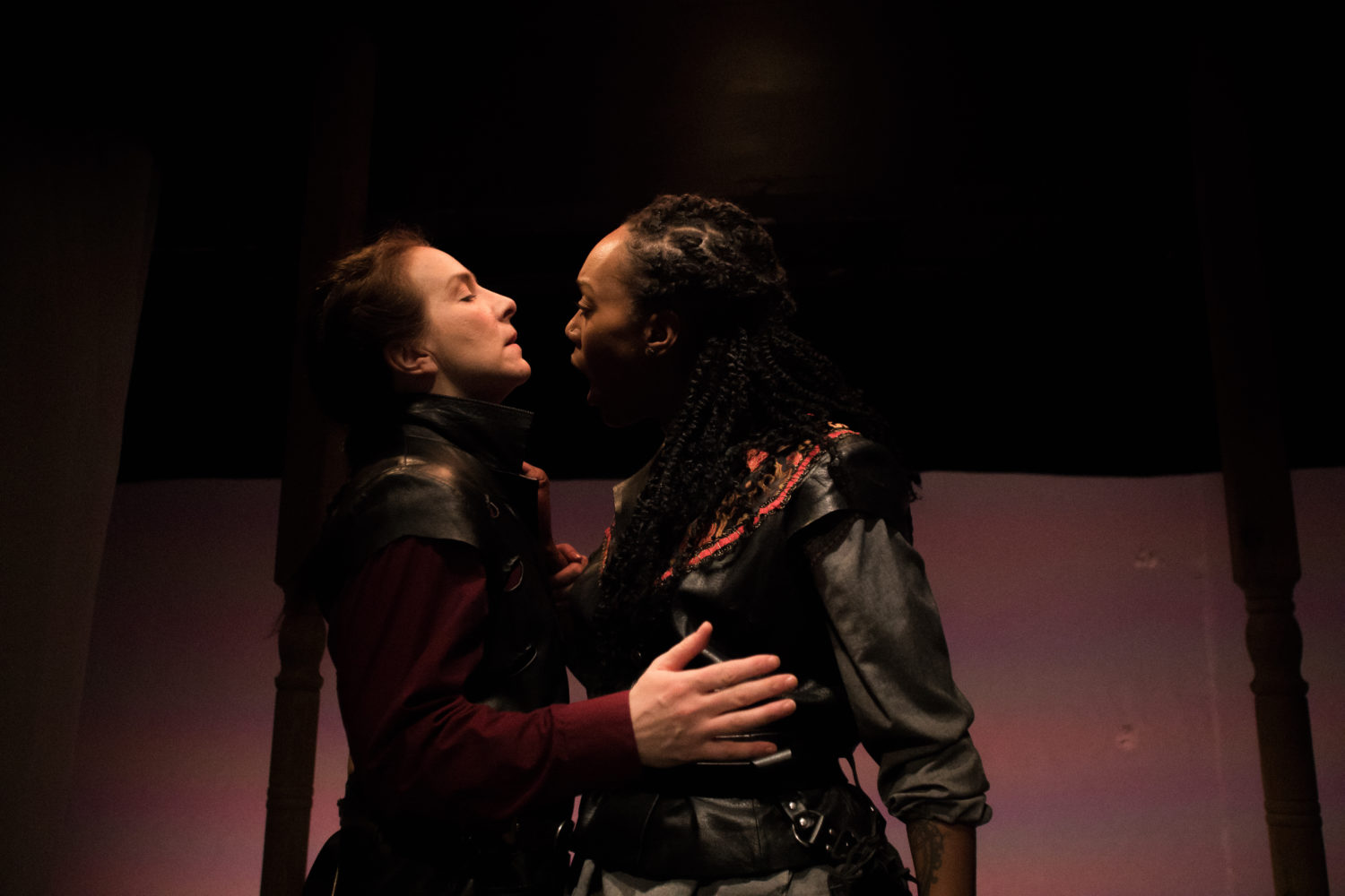 Othello grips Iago while Iago submits with open hands